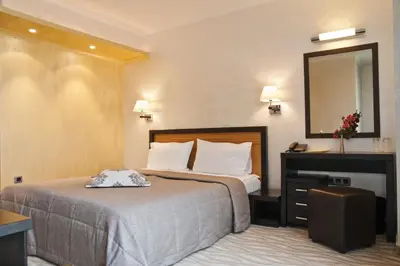 a hotel room with a bed and a mirror at Efbet Hotel in Varna City