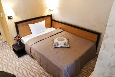 a hotel room with a bed with a pillow on it at Efbet Hotel in Varna City
