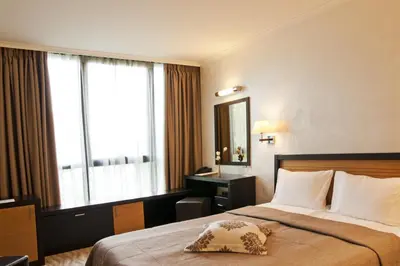 a hotel room with a bed and a window at Efbet Hotel in Varna City