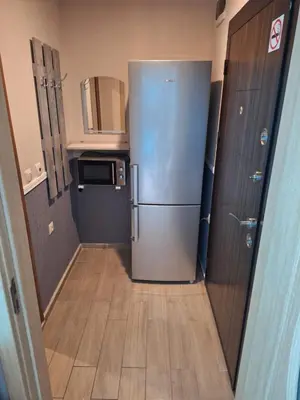 a kitchen with a stainless steel refrigerator in a room at Studio Eva 31 in Pomorie