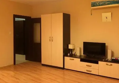 a living room with a television and a cabinet at Sirena Appartment in Sveti Vlas