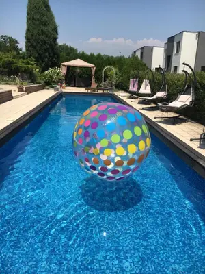 a large ball in the water in a swimming pool at Sea Dream Rental Apartments in Varna City