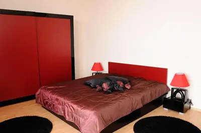 a person laying on a bed in a room at Sea Dream Rental Apartments in Varna City