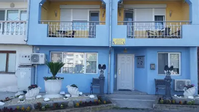 a blue building with chickens in front of it at Blue House in Tsarevo