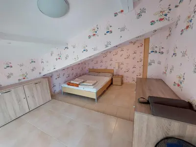 a bedroom with a bed in a attic at Fantastic Sea View Sun village Byala in Byala