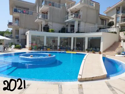 a large swimming pool in front of a building at Fantastic Sea View Sun village Byala in Byala