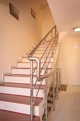 a staircase in a building with a metal railing at Rodos House in Pomorie