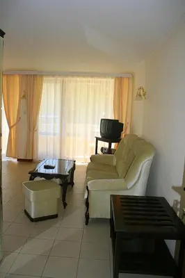 a living room with a couch and a table at Hotel Klisura in Sunny Beach