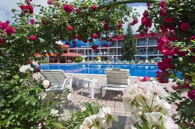a group of chairs sitting next to a swimming pool at Regina Hotel in Sunny Beach