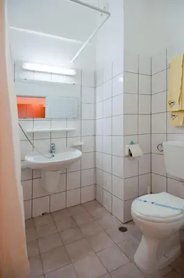 a bathroom with a toilet and a sink at Regina Hotel in Sunny Beach