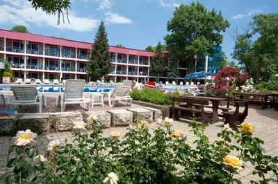 a group of chairs and tables in front of a building at Regina Hotel in Sunny Beach