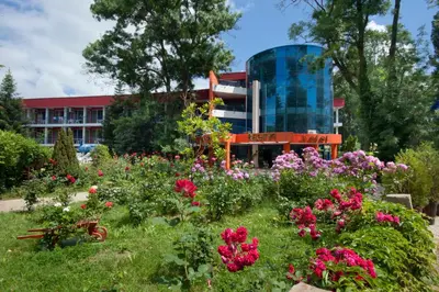 a garden with flowers in front of a building at Regina Hotel in Sunny Beach