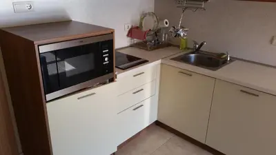 a kitchen with a microwave and a sink at Apartment in River Park in Sunny Beach