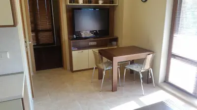 a kitchen with a table and two chairs and a television at Apartment in River Park in Sunny Beach