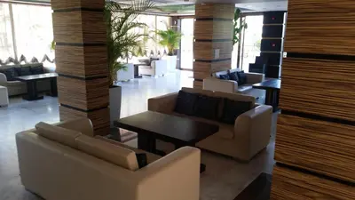 a lobby with couches and a table and chairs at Apartment in River Park in Sunny Beach