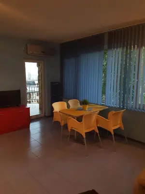 a dining room with a table and chairs and a television at Hotel Saint Tatyana in Sveti Vlas