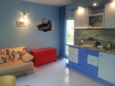 a kitchen with a couch and a sink and a counter at Hotel Saint Tatyana in Sveti Vlas