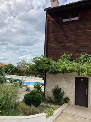 a brick building with a pool in the background at Apolon Complex in Sozopol