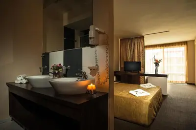 a bathroom with two sinks and a large mirror at Flagman Hotel in Sozopol