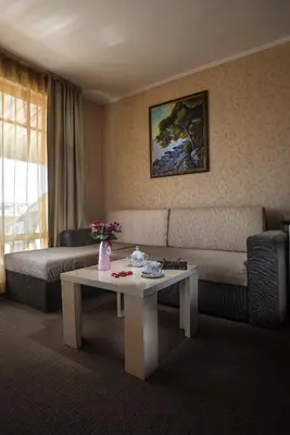 a living room with a couch and a table at Flagman Hotel in Sozopol