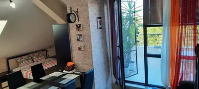 a room with a bedroom and a bed and a window at Студио Изгрев in Burgas City