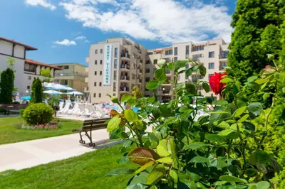a bush with a red flower in a park at TSB Sunny Victory in Sunny Beach