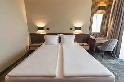 a large white bed in a hotel room at Kalithea Family Hotel in Sozopol