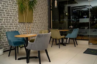 a group of tables and chairs in a restaurant at Gran Via in Burgas City