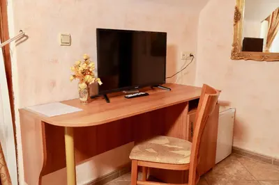 a wooden desk with a television on top of it at Family hotel Tropicana in Ravda