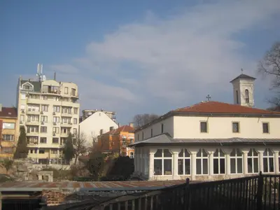 a large white building with a clock tower and buildings at Apartment Nadejda in Varna City