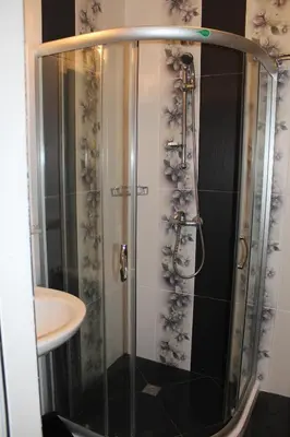 a shower with a glass door in a bathroom at Paradise Day in Pomorie
