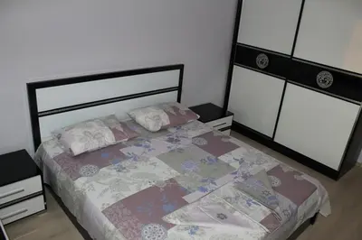a bedroom with a bed with a quilt and pillows at Paradise Day in Pomorie