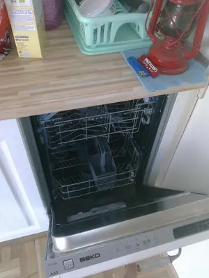 an oven with its door open on a shelf at Paradise Corner in Pomorie