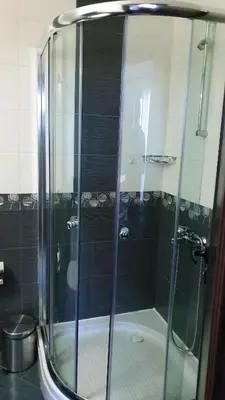 a shower with a glass door in a bathroom at апартамент CACAO RESIDENCE in Sunny Beach