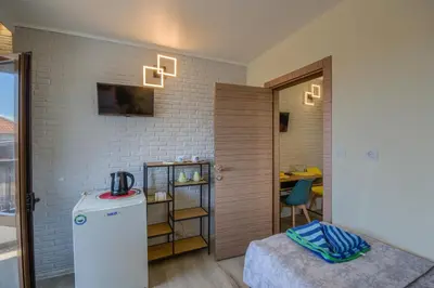a small room with a refrigerator and a table at Globus Kiten in Kiten