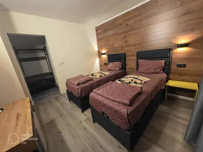 a hotel room with two beds and a mirror at Globus Kiten in Kiten