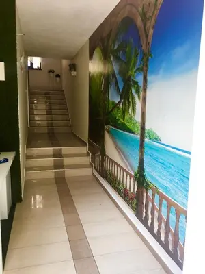 a hallway with a mural of the ocean and palm trees at Globus Kiten in Kiten