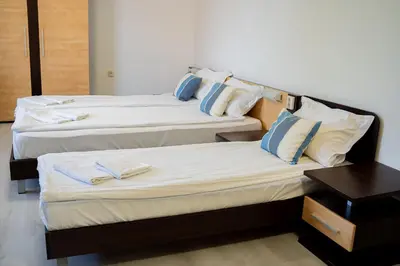 two beds in a hotel room with towels on them at Marianas Guesthouse in Obzor