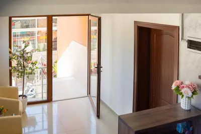 a room with a door and a vase of flowers at Marianas Guesthouse in Obzor