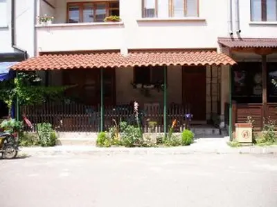 a building with an awning in front of a building at Стаи за гости Петрови in Primorsko