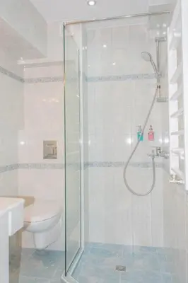 a bathroom with a shower and a toilet at Family Hotel Belle Epoque Beach in Varna City