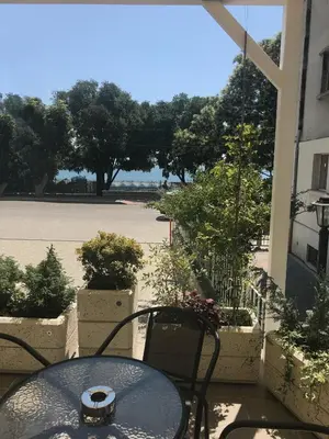 a table and chairs on a patio with a view of a courtyard at Family Hotel Belle Epoque Beach in Varna City