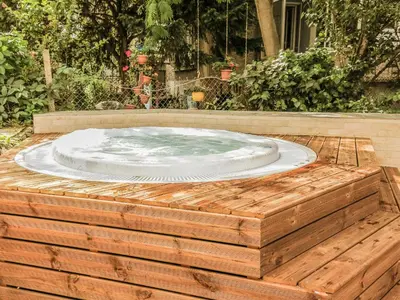 a hot tub sitting on top of a wooden deck at Family Hotel Belle Epoque Beach in Varna City