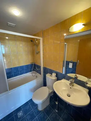 a bathroom with a toilet and a sink and a tub at Kaya Apartments in Sunny Beach
