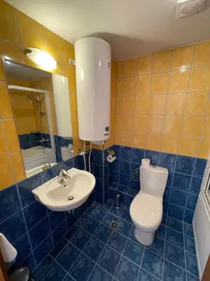 a bathroom with a toilet and a sink at Kaya Apartments in Sunny Beach