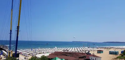 a beach with a lot of umbrellas and the ocean at Kaya Apartments in Sunny Beach