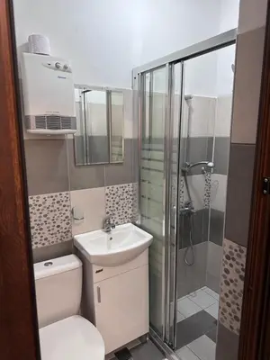 a bathroom with a toilet and a sink and a shower at Saraya in Varna City