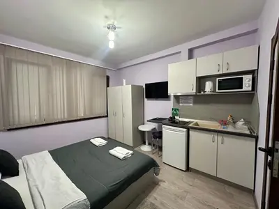 a small room with a bed and a kitchen at Saraya in Varna City