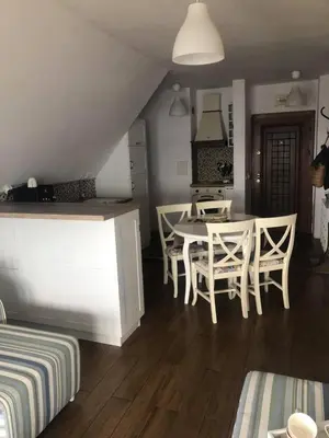 a kitchen and dining room with a table and chairs at Apartment Nadejda in Pomorie
