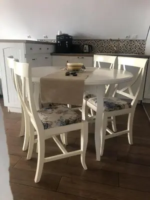 a white table and chairs in a kitchen at Apartment Nadejda in Pomorie